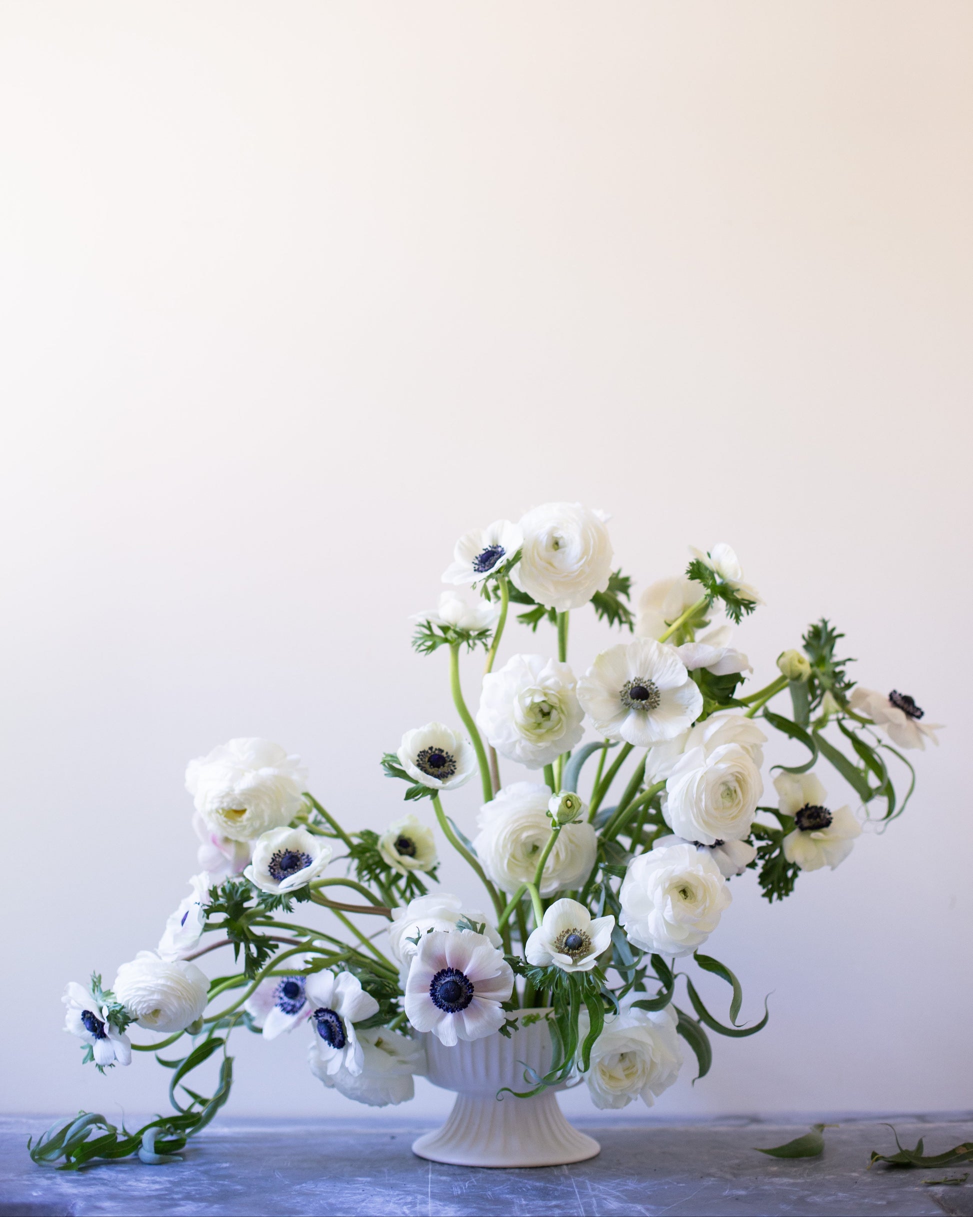 Floral arrangement in a white vase on a light background