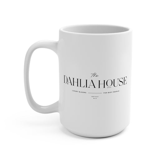 A white ceramic mug with 'The Dahlia House' text and a dahlia flower detail on the side.