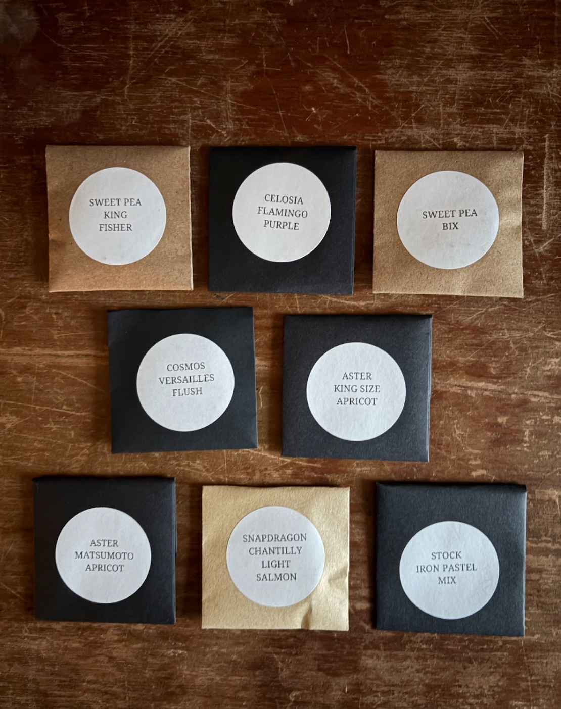 Set of seed packets with labels on a wooden surface