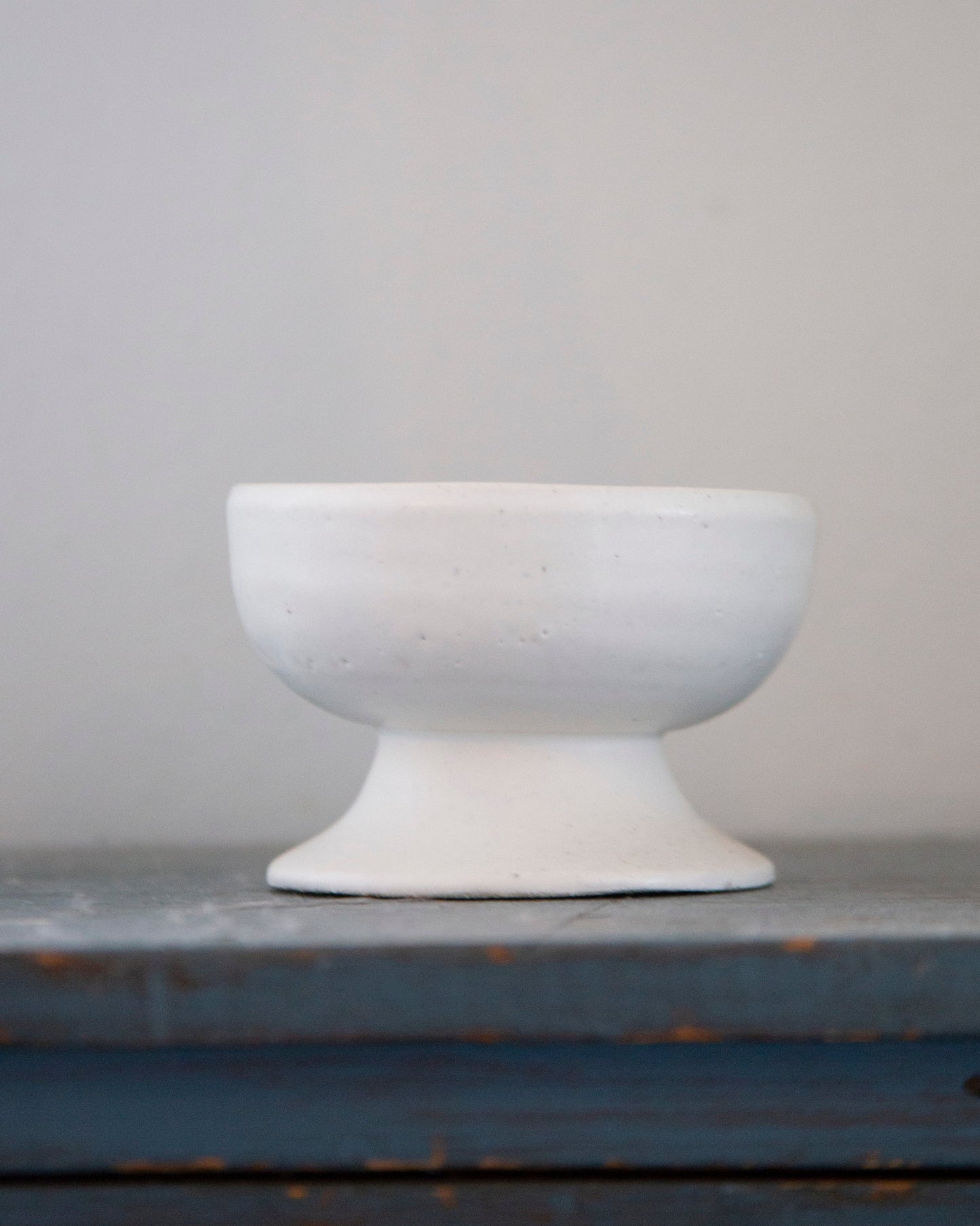 White ceramic bowl on a gray surface with a neutral background
